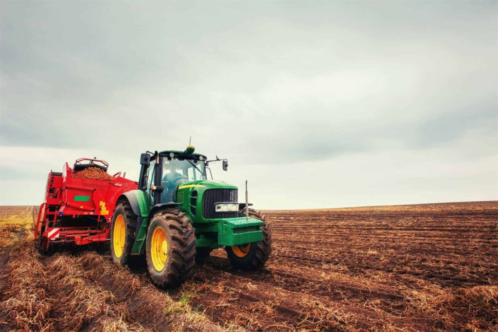 Tractor plowing farm field in preparation for spring planting.