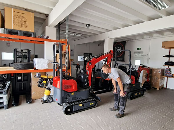 Customers receiving machinery in a workshop