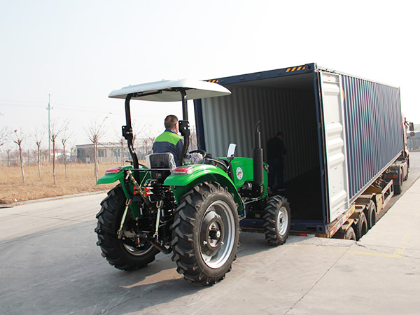 Tractor prepared beside a transport truck
