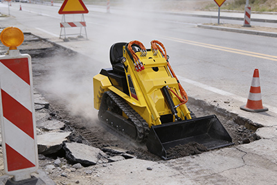 Skid steer loader for municipal maintenance